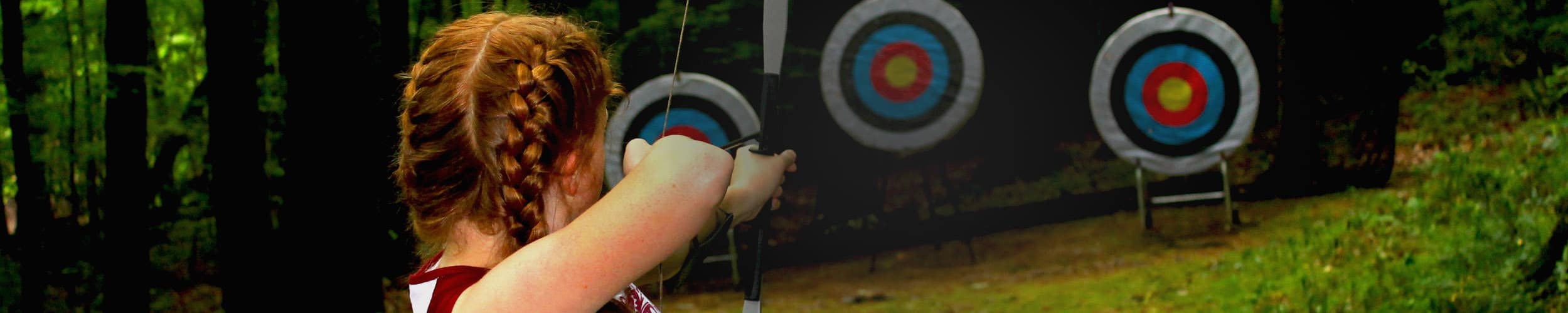 Little girl shooting a bow and arrow