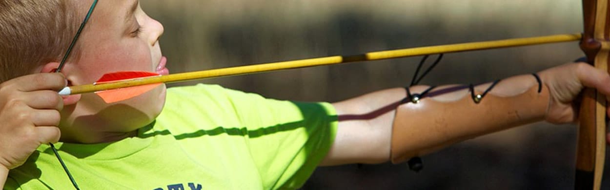 Young boy practicing archery