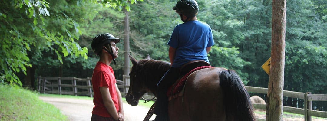 Learning horseback riding at summer camp