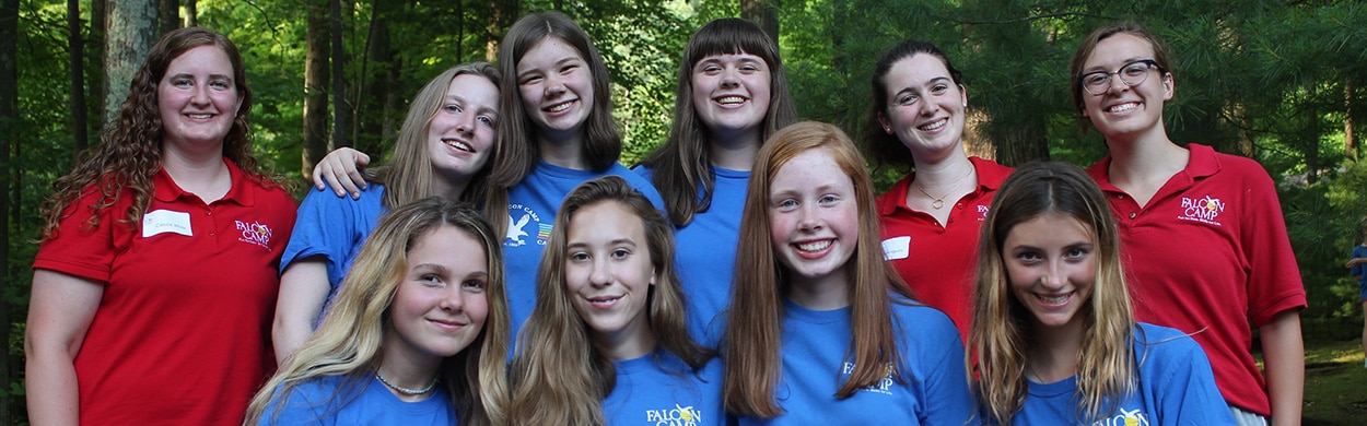 Female summer camp counselors with girl campers