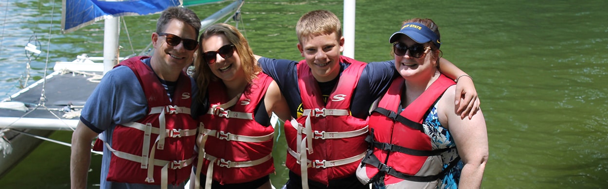 Campers with parents on the lake