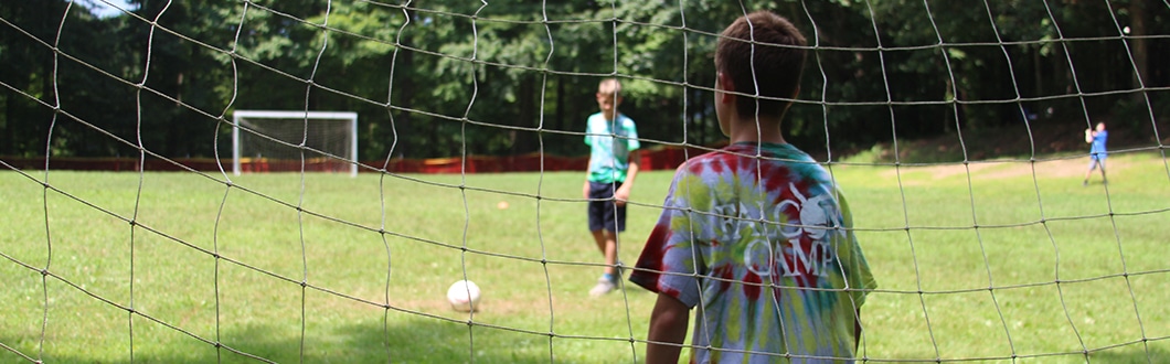 Campers playing soccer at summer camp