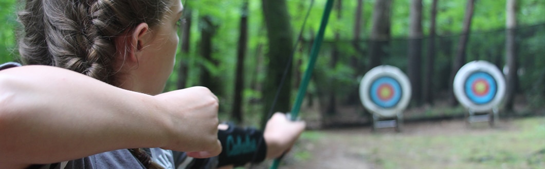 Learning archery at summer camp