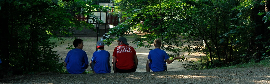 Male counselor with boys at summer camp