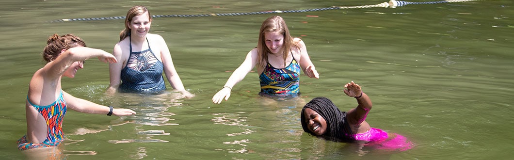 Girls swimming in the lake at summer camp