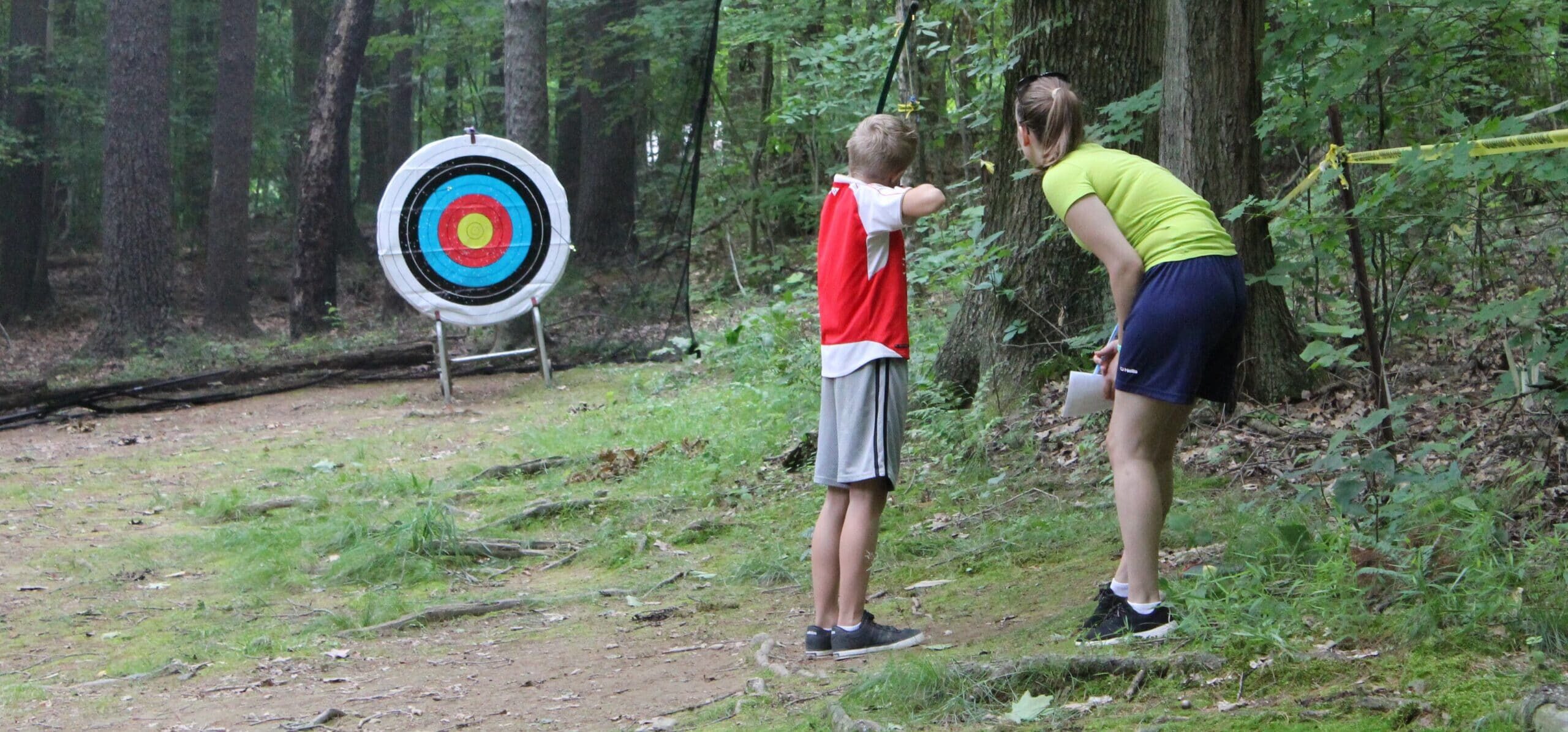 Learning archery at summer camp