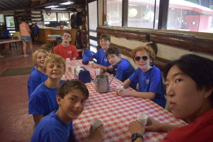 campers at dining table with leader